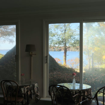 Summer screened inn porch overlooking Lake Geneva